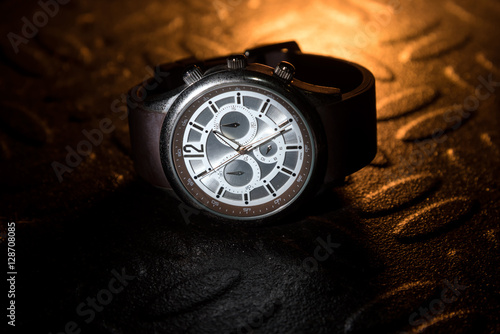 Vintage watch on a metal sheet with backlight color photo