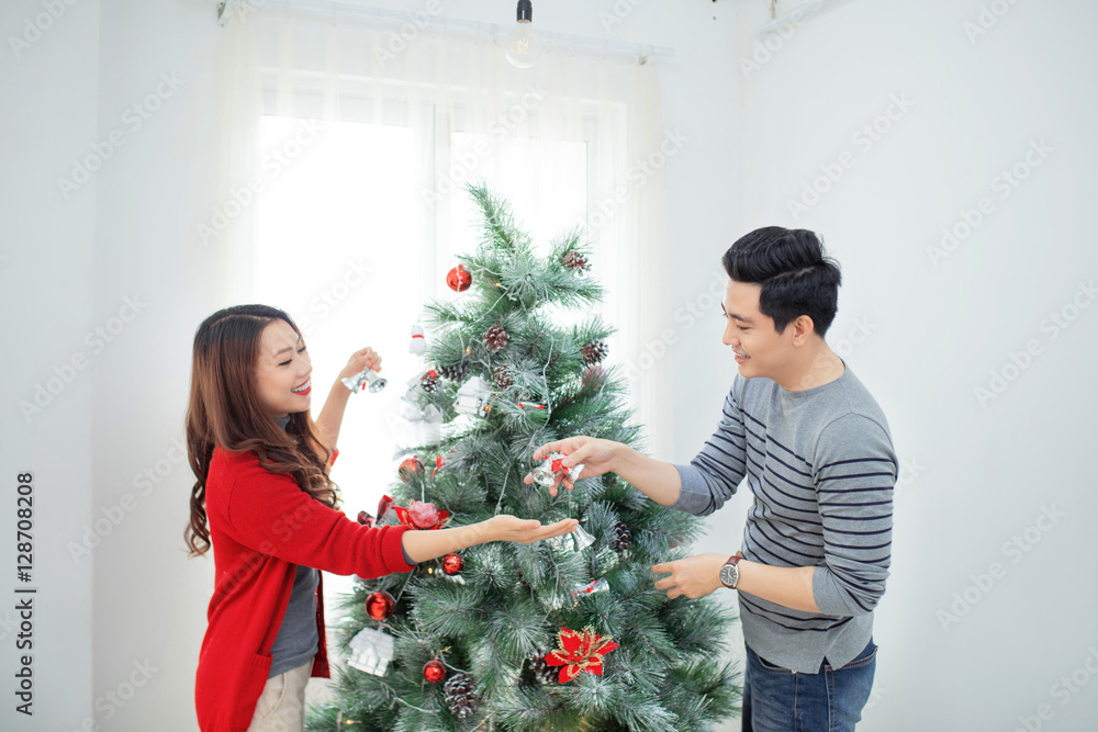 Christmas Asian Couple.Happy Smiling Family at home celebrating.