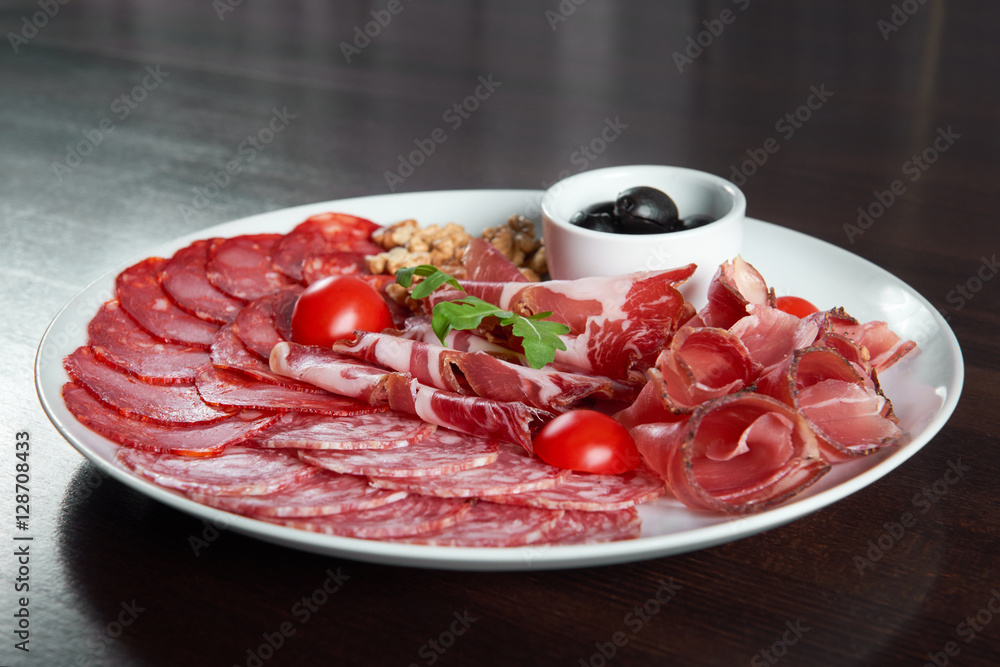 Assorted cold meat deli plate at the restaurant Assorted cold meat deli plate at the restaurant