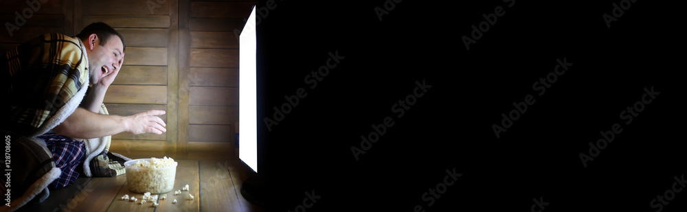 Fototapeta premium man watching television at home on the floor