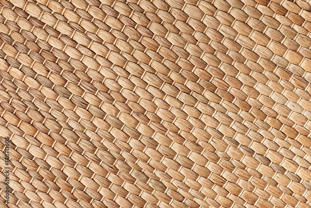 Bamboo woven beige mat handmade background. Wicker wood texture. Diagonal strips. Bamboo woven beige mat handmade background. Wicker wood texture. Diagonal strips.