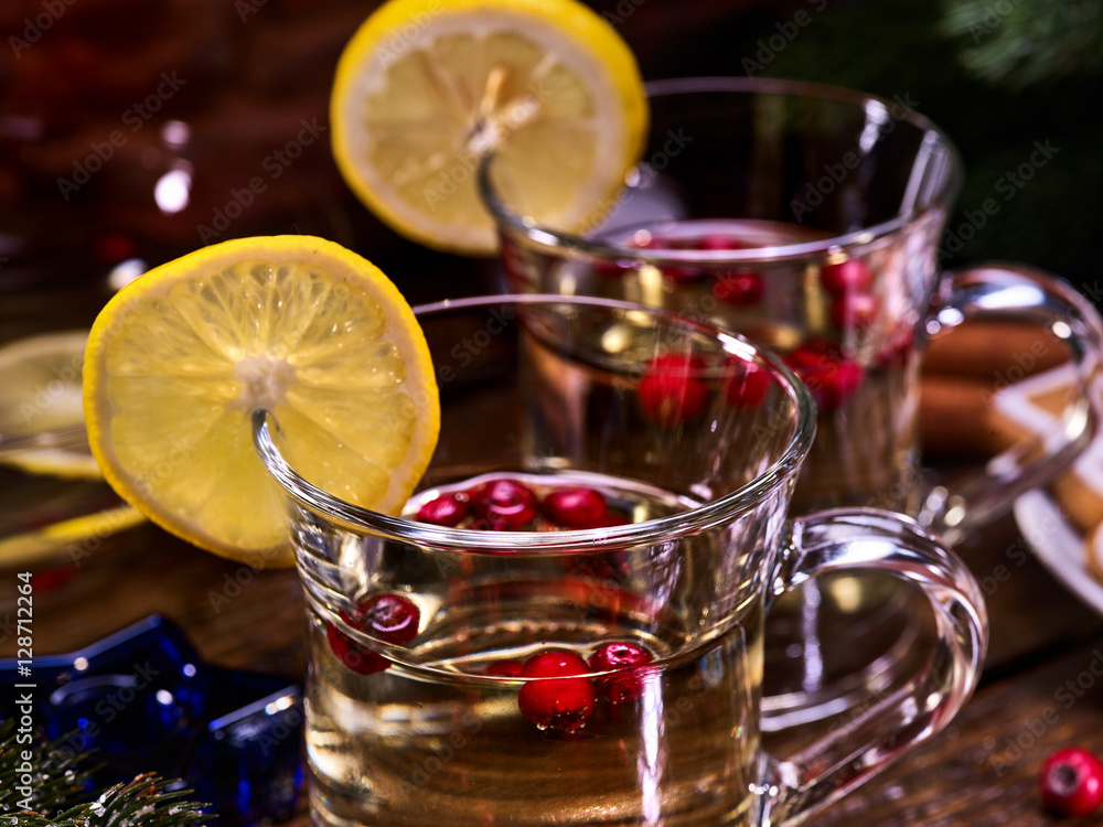 Close up of pair mug decoration lemon slice hot drink . Red berries into glass. Close up of pair mug decoration lemon slice hot drink . Red berries into glass.