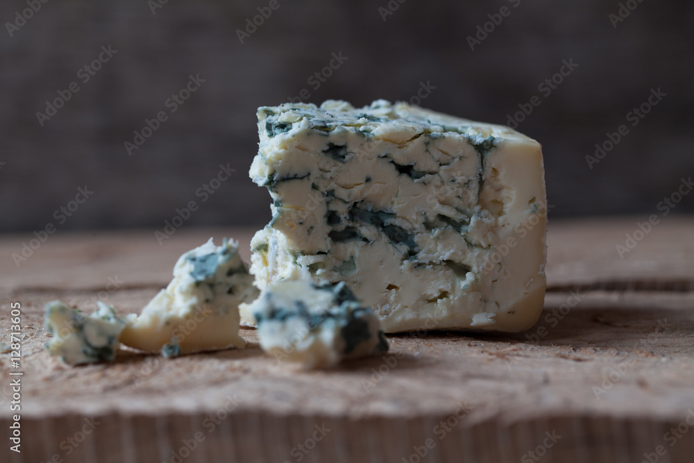 Slices of Danish Blue cheese on an wooden table, selective focus