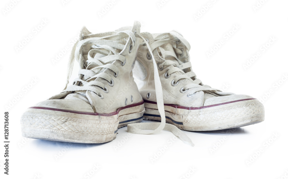 Old white sneakers on white background Old white sneakers on white background