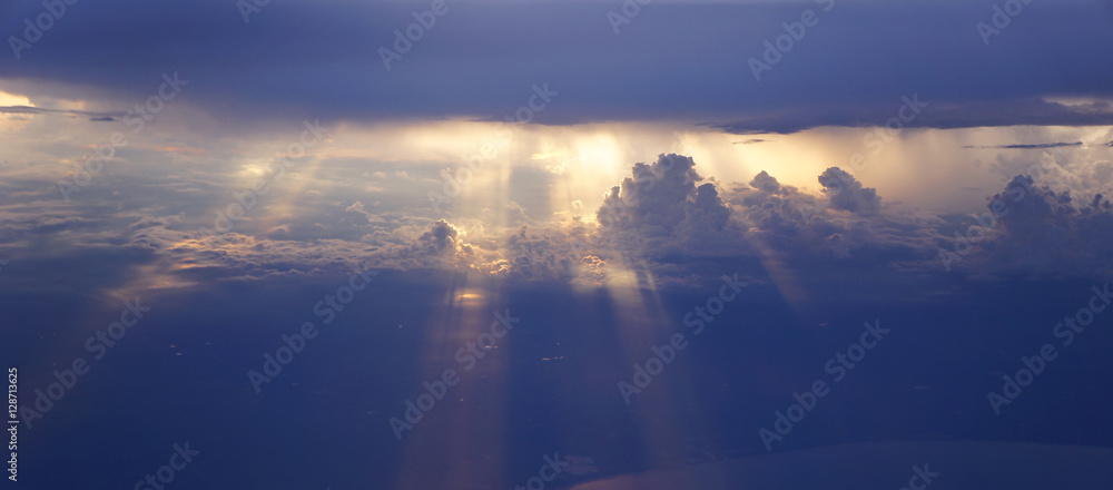 Light rays sunset shining through rich in space clouds,panorama Light rays sunset shining through rich in space clouds,panorama