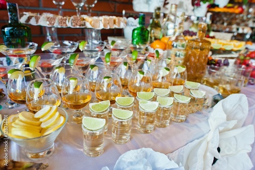 Glasses with lime and tequila at wedding reception