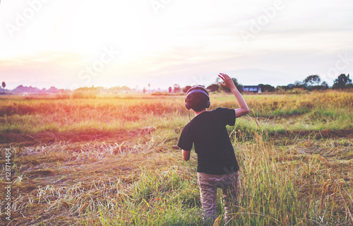 Music and dancing teens standing happily outside light nature sunset background.