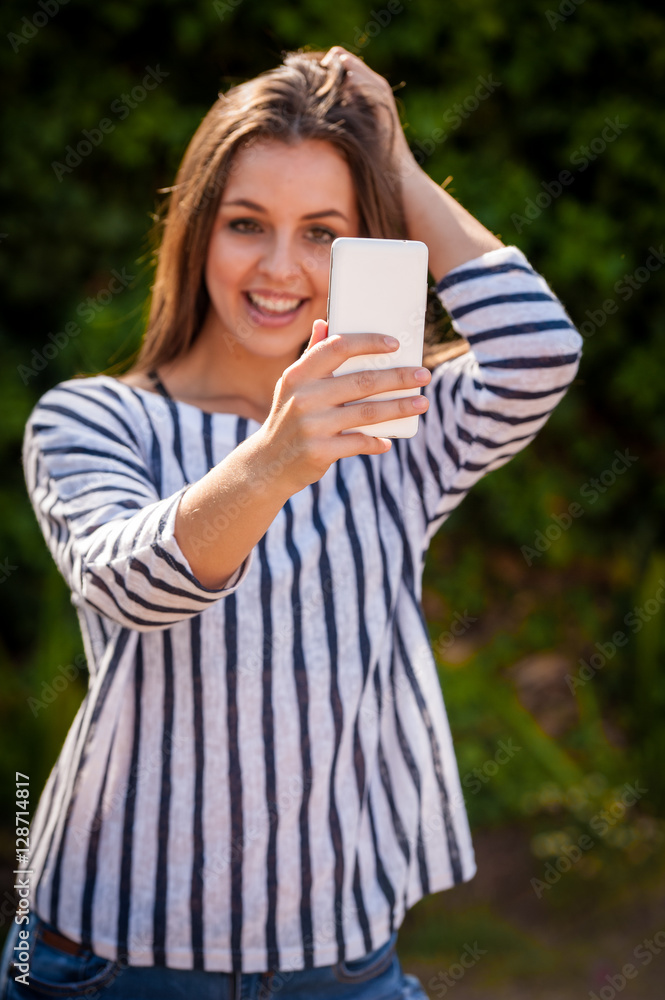 female on a smart phone outside female on a smart phone outside