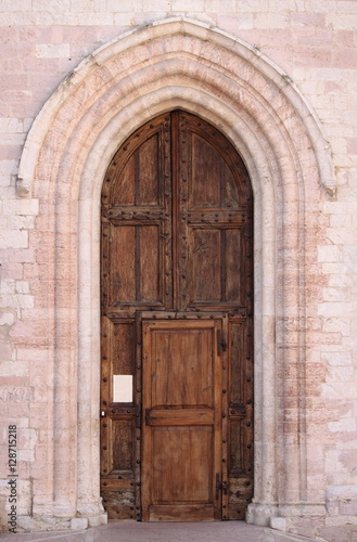 Entrance door of St. Claire Cathedral in Assisi, Italy © alessandro0770