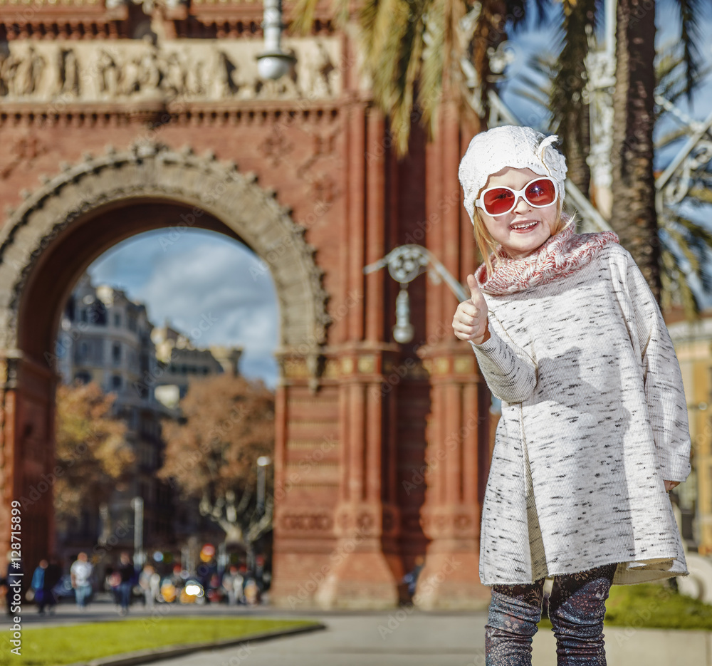 happy modern child in Barcelona, Spain showing thumbs up