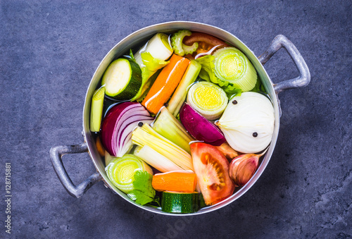 Vegetable stock or broth, vegetable soup top view copy space. photo