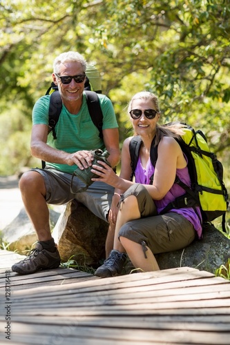 Couple smiling and taking a break during a hike 