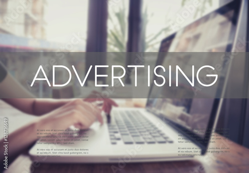 business hand typing on a laptop keyboard with Advertising homepage on the computer screen branding commerce concept.