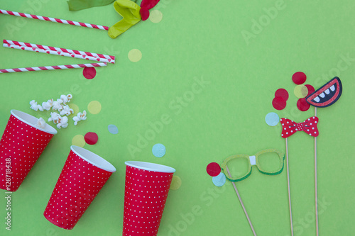 birthday, party items in a green background.Overhead shot

