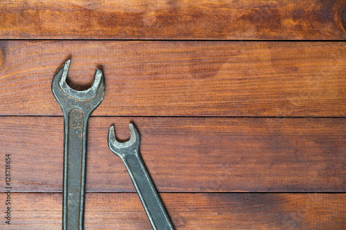 Rusty wrenches on dark wooden background. Empty space for designners.