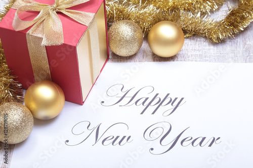 Text merry christmas on paper with balls and gift box