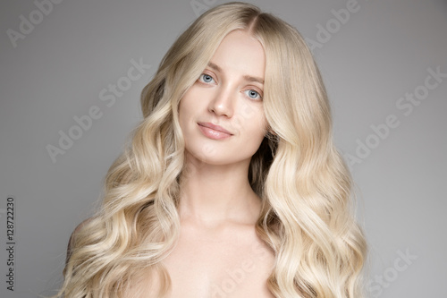 Portrait Of A Beautiful Young Blond Woman With Long Wavy Hair.