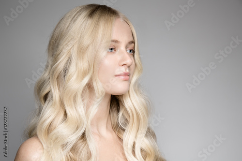 Portrait Of A Beautiful Young Blond Woman With Long Wavy Hair.