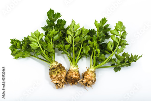 Root of celery with leaves isolated on white, green vegetables