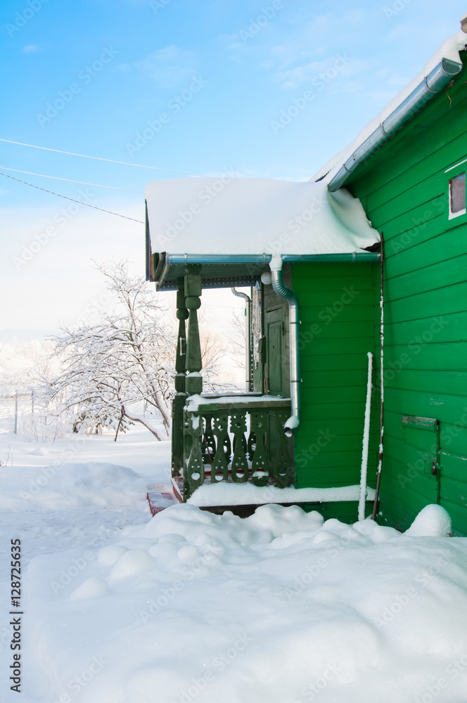 Snowy front steps of country house in russian village in winter Snowy front steps of country house in russian village in winter