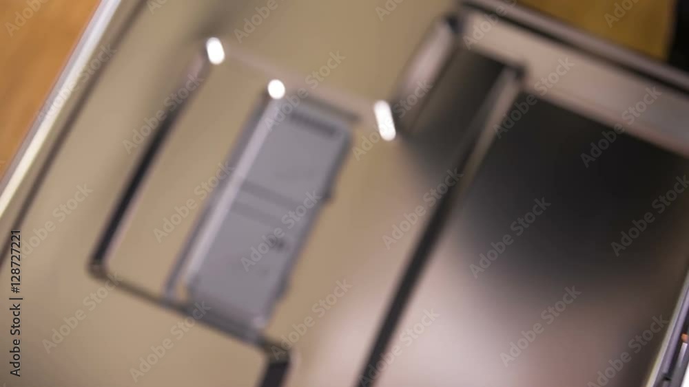 A young woman is placing a few plastic spoons on the top shelf of the dishwasher and then she is closing it.
A young woman is placing a few plastic spoons on the top shelf of the dishwasher and then she is closing it.
