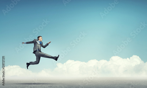 Wallpaper Mural Businessman jumping high Torontodigital.ca