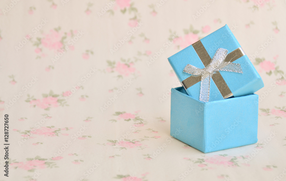Christmas background - Blue small gift boxes on hand with decorations small gift boxes on wooden board background.

