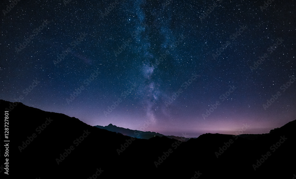 purple night sky stars. Milky way galaxy across mountains. Starr