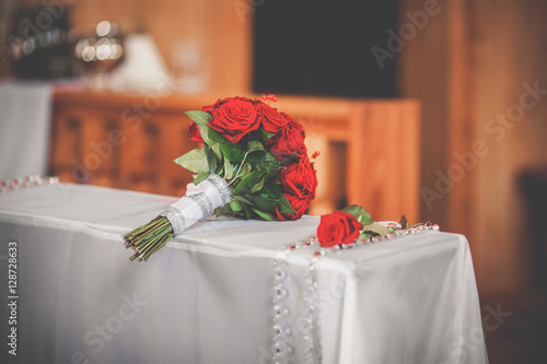Bild auf Leinwand wedding bouquet lying on kneeler during wedding ceremony in church