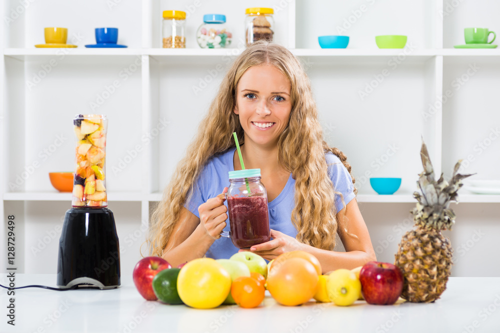 Beautiful girl is making and drinking smoothies at her home.
Beautiful girl is making and drinking smoothies at her home.