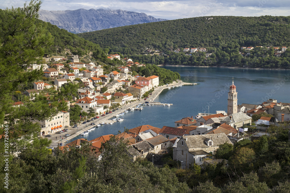 Red roofs and white stone houses in deep bay in village Pucisca on island Brac in Croatia