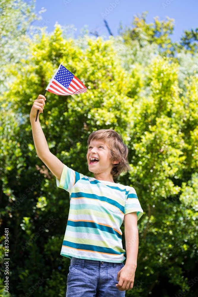 A little boy is holding an american flag Stock Photo | Adobe Stock