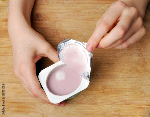 Yogurt with mold in female hands