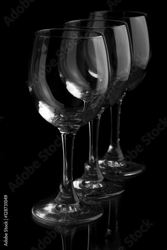 Three elegant wine glasses in a black background.