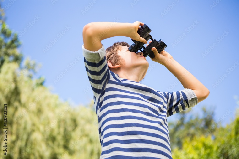 Low angle view of a child looking something with binoculars Low angle view of a child looking something with binoculars