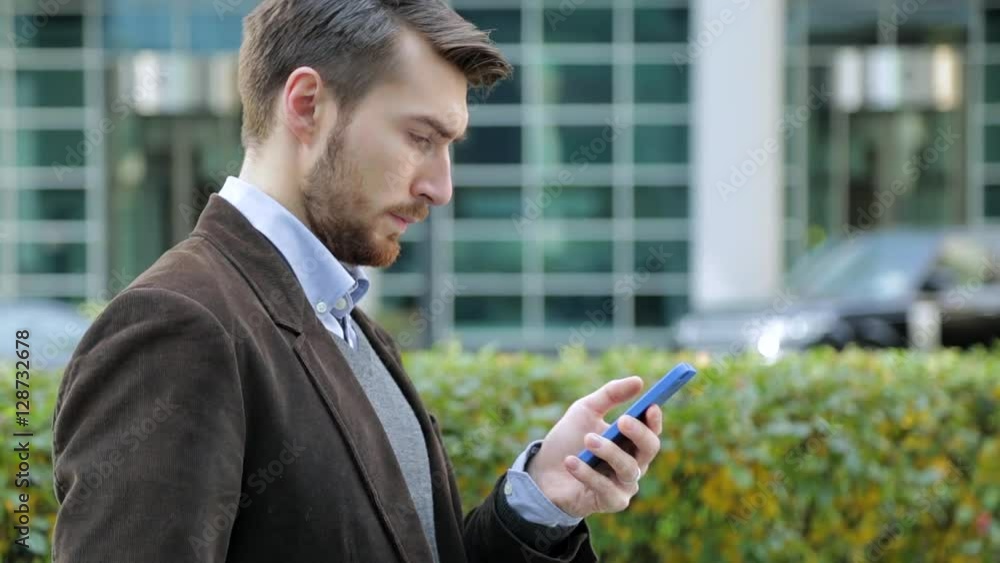 Attractive man using app on smartphone, smiling