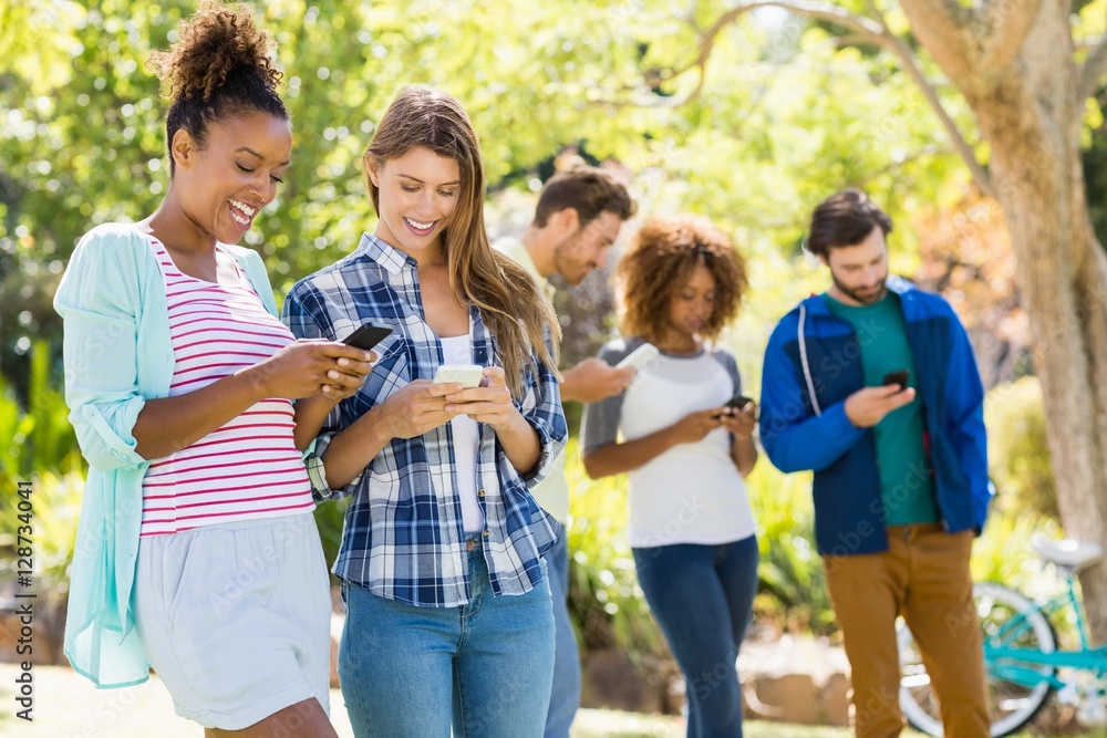 Group of friends using mobile phone