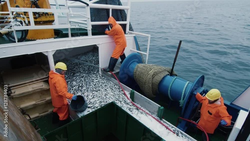 Crew of Fishermen Open Trawl Net with Caugth Fish on Board of Commercial Fishing Ship.  Shot on RED Cinema Camera in 4K (UHD). 