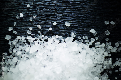 Coarse salt on a dark background photo