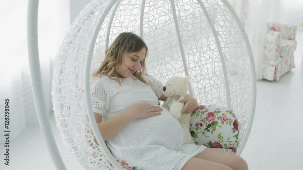 Expectant mother on a swing. Expectant mother on a swing.