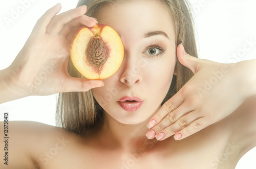 Surprised girl with half of peach