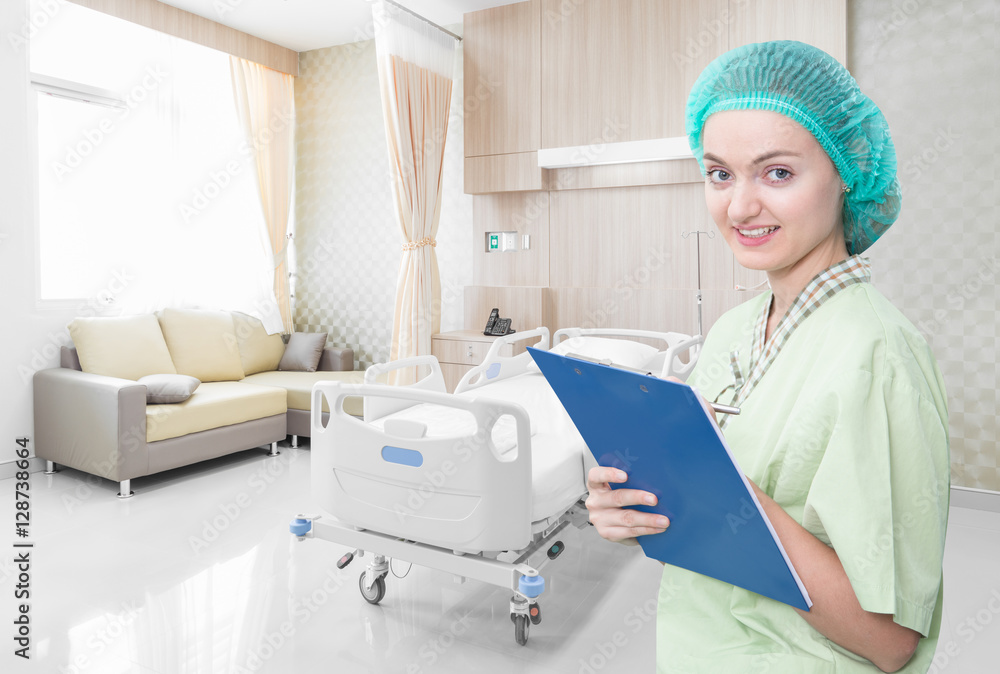 Nurse writing medical records in modern hospital room with beds Nurse writing medical records in modern hospital room with beds