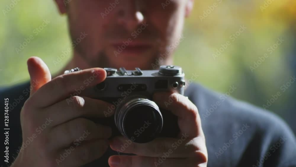 Male tourist holding hands in a retro camera Male tourist holding hands in a retro camera