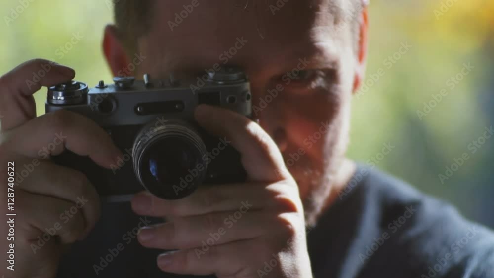 Male tourist holding hands in a retro camera Male tourist holding hands in a retro camera