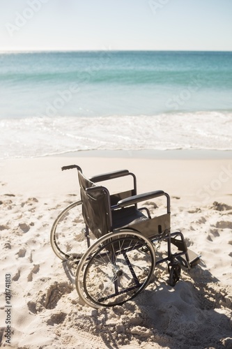 Black wheelchair on the beach