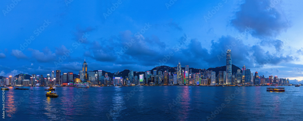 Evening panoramic view of the lighted Victoria Harbour in Hong Kong