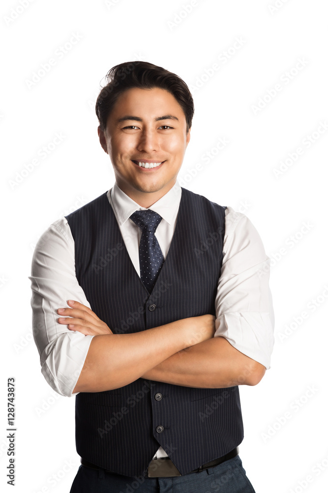 A trendy and fashionable businessman wearing a blue vest, tie and shirt. Standing against a white background smiling. A trendy and fashionable businessman wearing a blue vest, tie and shirt. Standing against a white background smiling.