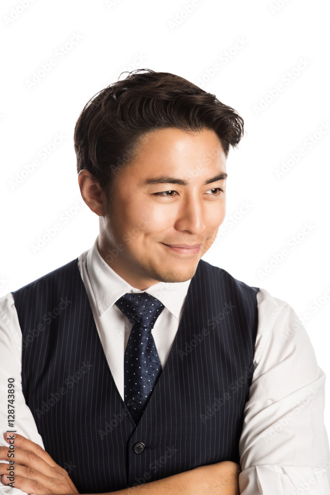 A trendy and fashionable businessman wearing a blue vest, tie and shirt. Standing against a white background smiling. A trendy and fashionable businessman wearing a blue vest, tie and shirt. Standing against a white background smiling.