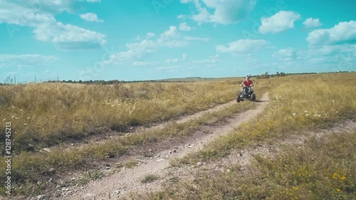 Wallpaper Mural A young man riding a quad bike on a field. Torontodigital.ca
