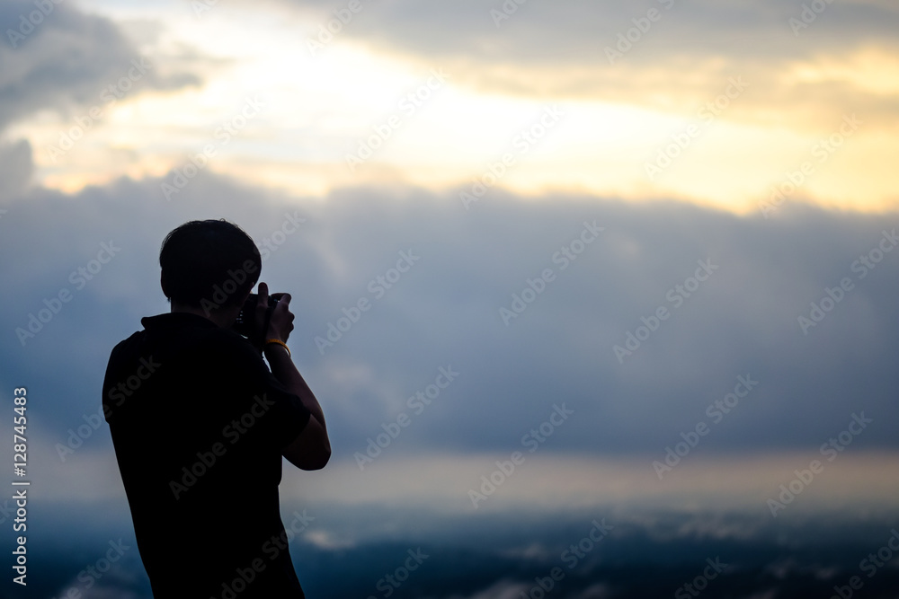 silhouette of the man. in his hand have a camera. he is taking a photo. silhouette of the man. in his hand have a camera. he is taking a photo.